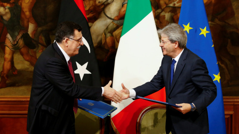 El primer ministro italiano Paolo Gentiloni (D) y su homólogo libio Fayez al-Sarraj se dan la mano después de firmar un acuerdo bilateral durante una reunión en Palacio de Chigi en Roma, Italia, el 2 de febrero de 2017.- REUTERS / Tony Gent El primer ministro italiano Paolo Gentiloni (D) y su homólogo libio Fayez al-Sarraj se dan la mano después de firmar un acuerdo bilateral durante una reunión en Palacio de Chigi en Roma, Italia, el 2 de febrero de 2017.- REUTERS / Tony Gent