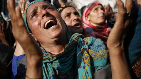 Mujeres cachemiras rezan mientras un clérigo enseña la reliquia del jeque Syed Abdul Qadir Jeelani en su templo en Srinagar, la capital estival de la parte de Cachemira administrada por la India. EFE/Farooq Khan