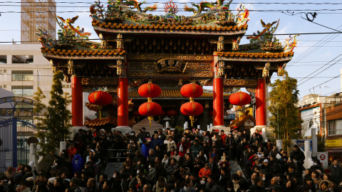La gente espera sentada a baile de los leones en el Templo de Kanteibyo en Yokohama, al sur de Tokio, Japón. REUTERS/Thomas Peter