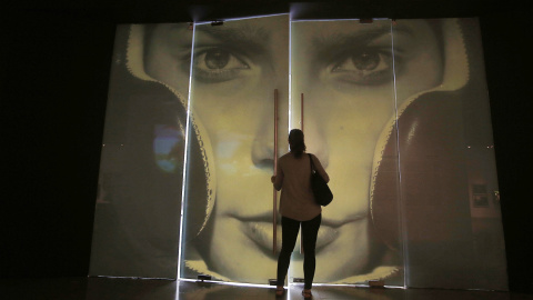 Una mujer entra en la exposición fotográfica 'Álbum de Chile' en el Centro Cultural Palacio de La Moneda, en Santiago de Chile. EFE/Mario Ruiz