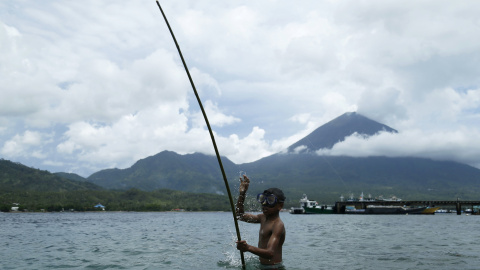 Un niño sostiene una caña de pescar en la playa de la isla de Maitara en Tidore, Indonesia. REUTERS/Beawiharta
