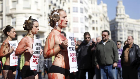 Activistas de la organización Anima Naturalis semidesnudos y teñidos de rojo se concentran en la plaza del Ayuntamiento de Valencia para reclamar unas Fallas sin tauromaquia. EFE/Kai Försterling