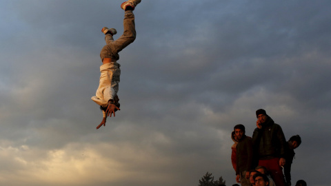 Un grupo de inmigrantes y refugiados bailan y cantan en uno de los campos de acogida cerca de Idomeni, Grecia. REUTERS/Marko Djurica