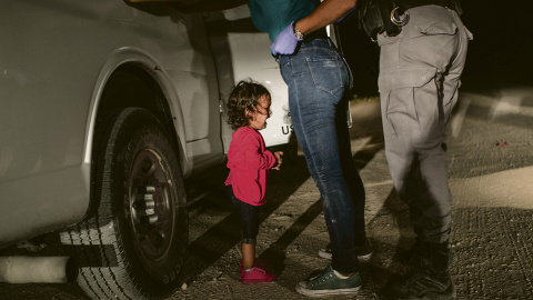 005_John Moore_Getty Images A two-year-old Honduran asylum seeker cries as her mother is searched and detained near the U.S.-Mexico border on June 12, 2018 in McAllen, Texas. They had rafted across the Rio Grande from Mexico and were detained by U.S. Border Patrol age