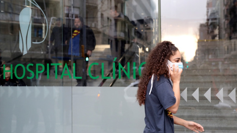 Woman in a protective face mask walks out of a Hospital Clinic, where a case of novel coronavirus has been confirmed, in Barcelona | reuters