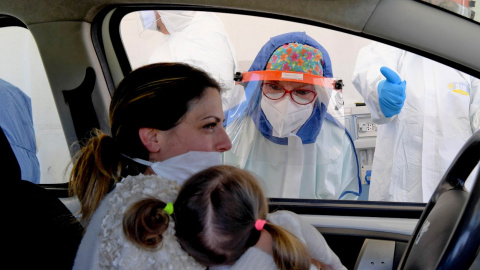 Una mujer y su hija se someten a un test para detectar el coronavirus desde su coche en la ciudad de Pozzuoli, cerca de Nápoles (Italia) /EFE