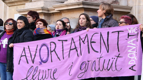 Un grup de dones del col·lectiu feminista Adona't de Vic sosté una pancarta a favor del dret a l'avortament durant la protesta que han protagonitzar aquest diumenge al matí davant la Catedral de Vic. Imatge del 8.01.2016