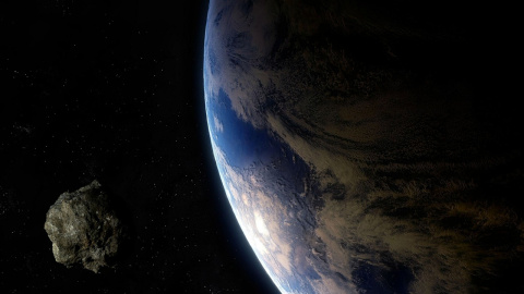 Ilustración de un asteroide y la Tierra.