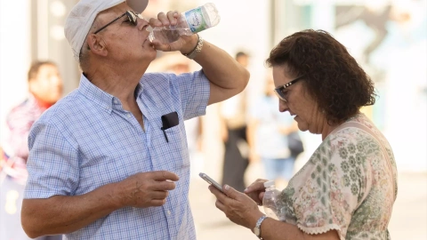 Una persona bebe agua para refrescarse ante las altas temperaturas, a 6 de octubre de 2023, en Madrid.