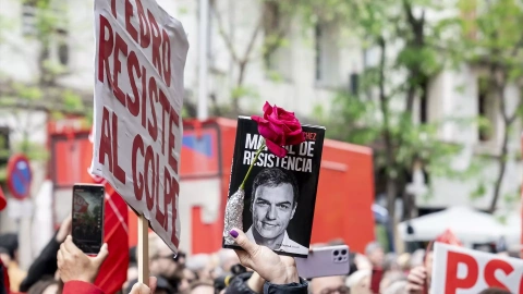 Una persona sujeta un cartel durante una concentración en la calle de Ferraz en apoyo al presidente del Gobierno, Pedro Sánchez, en la sede del PSOE, a 27 de abril de 2024