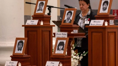 Urns holding the remains of five students killed by a military squad during a raid at a university campus 31 years ago are displayed during a religious ceremony in their honour on September 1, 2023, in Lima, after the remains were handed ov