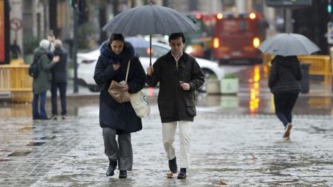 Varias personas se protegen de la lluvia en València, a 5 de marzo de 2025. Varias personas se protegen de la lluvia en València, a 5 de marzo de 2025.