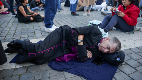 Un clérigo descansa en la Plaza de San Pedro, el primer día del cónclave para elegir al nuevo papa, en el Vaticano, a 7 de mayo de 2025. Un clérigo descansa en la Plaza de San Pedro, el primer día del cónclave para elegir al nuevo papa, en el Vaticano, a 7 de mayo de 2025.