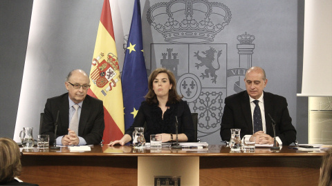La exvicepresidenta Soraya Saez de Santamaría, entre los exministros de Hacienda, Cristóbal Montoro (i), y de Interior, Jorge Fernández Díaz, en una imagen de archivo tomada en La Moncloa.