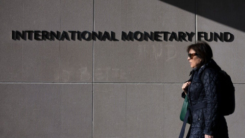 Una mujer pasa frente al Fondo Monetario Internacional, en Washington, D. C.