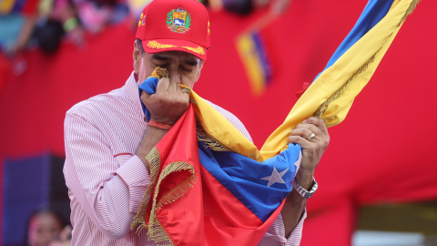 El presidente de Venezuela, Nicolás Maduro, besa una bandera durante una movilización este lunes en Caracas. .