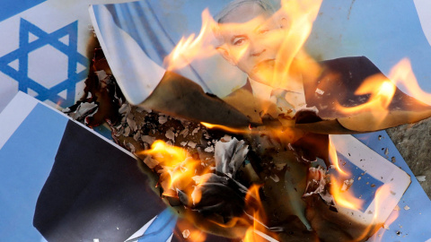 Los somalíes queman la bandera de Israel y una imagen que representa al primer ministro israelí, Benjamin Netanyahu, durante una manifestación contra la decision de Tel Aviv de reconocer a la República de Somalilandia