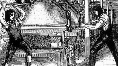 Una ilustración muestra a unos obreros golpeando una máquina.