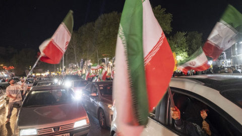 Un simpatizante del Gobierno iraní ondea una bandera nacional en el norte de Teherán.