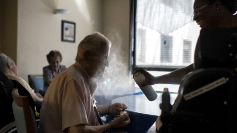 AFP__20150702__Par8217899__v2__MidRes__FranceElderlyWeather Una enfermera rocía agua en la cara de un hombre en una residencia de ancianos. Imagen de archivo.