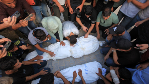 Un grupo de personas lloran la muerte de ciudadanos palestinos asesinados por un ataque aéreo israelí. Un grupo de personas lloran la muerte de ciudadanos palestinos asesinados por un ataque aéreo israelí.