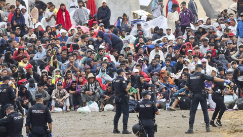Migrantes en Ceuta La policía vigila a inmigrantes que continúan viviendo en las inmediaciones de la playa del Trampolín en Ceuta, este viernes.