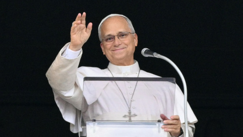 Pope Leo XIV waves from the window of the apostolic palace overlooking St. Peter's square during the Angelus prayer a day after his return to The Vatican following a surgery to remove a cancerous tumour in his right lung, on October 18, 2026. (Photo by Tiziana FABI / AFP)