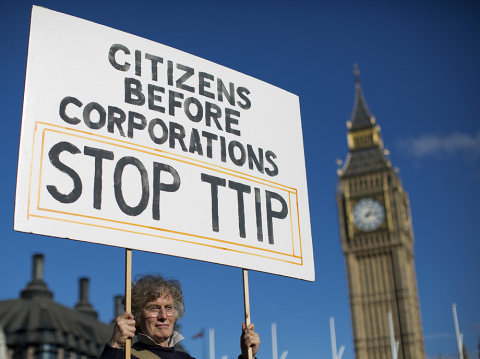 A woman demonstrates in central London on October 11, 2014, against the proposed Transatlantic Trade and Investment Partnership (TTIP). Brussels released the playbook for its talks with Washington on a giant EU-US trade deal on Thursday, saying it wanted 