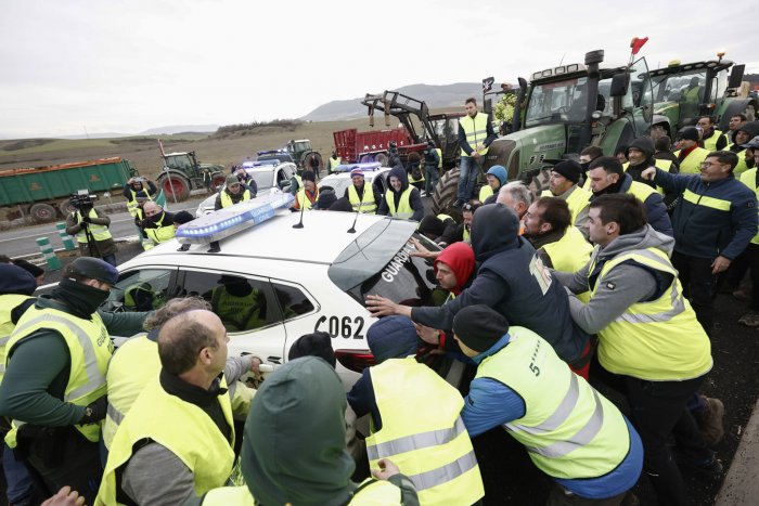 Agricultores navarros zarandean dos coches de la Guardia Civil que les cortaban el paso hacia Pamplona