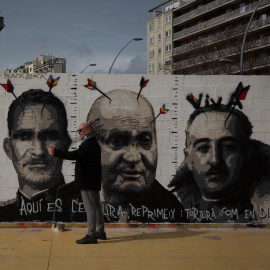 Mural en Barcelona con las imágenes asaetadas de Felipe de Borbón, Juan Carlos de Borbón y Francisco Franco, en una fotograf de archivo.