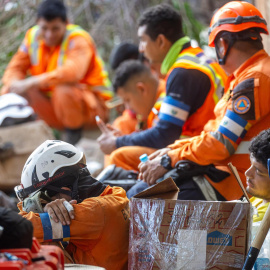 Rescatistas de El Salvador descansan en medio de las labores de búsqueda de sobrevivientes a los terremotos, este martes en Catia La mar, La Guaira (Venezuela).