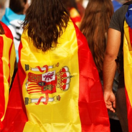  Tres personas con la senyera, la bandera española y la estelada.- REUTERS