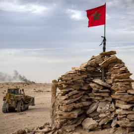  Imagen de archivo del 23 de noviembre de 2020 de una excavadora y una bandera de Marruecos en la carretera ubicada en El Guerguerat, frontera del Sáhara Occidental.- AFP