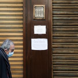  Un anciano con mascarilla pasa delante de un restaurante de cinco tenedores, en el centro de Madrid, cerrado por el estado de alarma por el coronavirus. REUTERS/Susana Vera