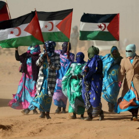  Varias mujeres sostienen banderas del Sáhara Occidental en la ceremonia del 40 aniversario de la proclamación de la República Árabe Saharaui Democrática, en febrero de 2016.- AFP