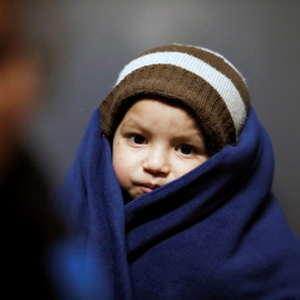 A migrant boy is seen waiting after he was brought to a coast guard station at the Turkish coastal town of Dikili