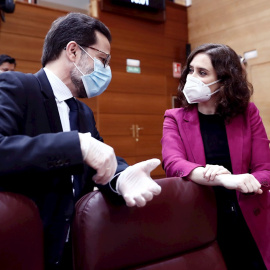 14/05/2020.- La presidenta de la Comunidad de Madrid, Isabel Díaz Ayuso (d) conversa con el consejero de Hacienda, Javier Fernández-Lasquetty (i) antes del comienzo de la sesión de control al ejecutivo regional en la Asamblea de Madrid este jueves dond