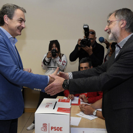 El expresidente del Gobierno José Luis Rodríguez Zapatero saluda al presidente de la mesa, tras depositar su voto en la sede provincial del PSOE en León, dentro del proceso de primarias. EFE/J. Casares