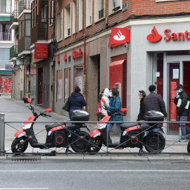 Varias personas esperan para entrar a una oficina del Banco Santander durante el estado de alarma, en Madrid. E.P./Marta Fernández