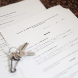 Unas llaves sobre un contrato de compraventa de vivienda y un contrato de arrendamiento (alquiler) de una habitación en una vivienda compartida. / ARCHIVO EUROPA PRESS