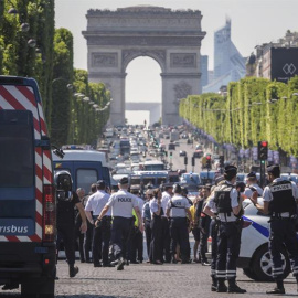 Agentes de policía galos permanecen en guardia en la céntrica avenida de los Campos Elíseos, donde un coche ha impactado contra un furgón de la Gendarmería francesa. EFE/Christophe Petit Tesson