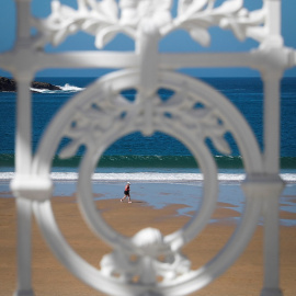 11/03/2020.- Una mujer pasea este miércoles por la orilla de la playa de La Concha de San Sebastián. / EFE - JAVIER ETXERARRETA