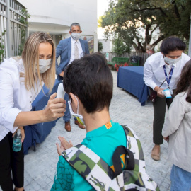Una trabajadora toma la temperatura a un niño a la entrada del colegio privado internacional American School of Barcelona, en Esplugues de Llobregat (Barcelona). EFE/ Marta Perez/Archivo