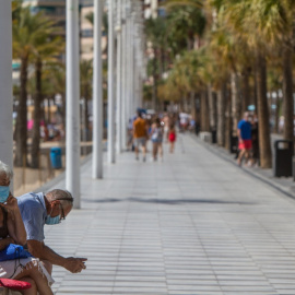 Dos personas descansan en el paseo marítimo de Benidorm, Alicante el 27 de septiembre de 2020. Lars Ter Meulen / Europa Press