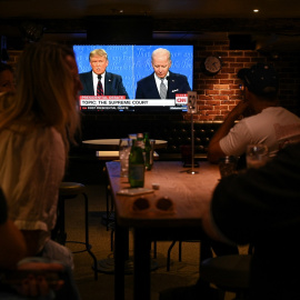 30/09/2020 - Personas miran el primer debate presidencial de Estados Unidos en un bar de Sídney. / REUTERS - LOREN ELLIOTT
