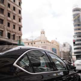 Un coche de Uber circula por la calle Gran Vía de Madrid. Uber