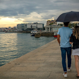 Una pareja de turistas pasea por Santander.