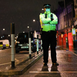 Un policía hace guardia en en la estación de Policía de Edmonton, en Enfield.