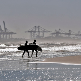 Dos surfistas salen de la playa de La Malvarrosa de València donde las olas y el cielo despejado han animado a numerosas practicantes de este deporte a acercarse al mar.