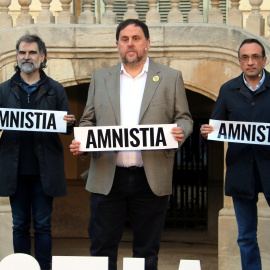 Imatge d'Oriol Junqueras, Jordi Cuixart i Josep Rull amb pancartes reclamant l'amnistia en un imatge d'arxiu